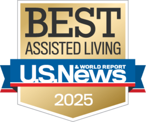 A gold badge with the text “Best Assisted Living” above the U.S. News & World Report logo and “2025” at the bottom, indicating a 2025 award for top assisted living facilities.