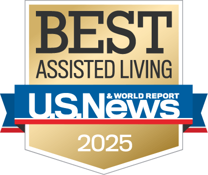 A gold badge with the text โBest Assisted Livingโ above the U.S. News & World Report logo and โ2025โ at the bottom, indicating a 2025 award for top assisted living facilities.