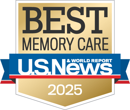 Gold badge with the text “Best Memory Care” above a blue, white, and red ribbon featuring the U.S. News & World Report logo, and “2025” at the bottom.