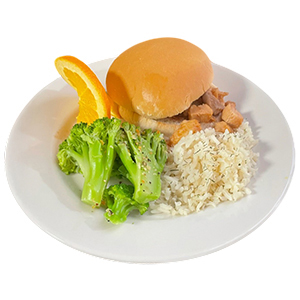 A white plate with steamed broccoli, white rice, diced chicken in sauce, a sandwich bun, and an orange slice—perfectly balanced for senior living dining.