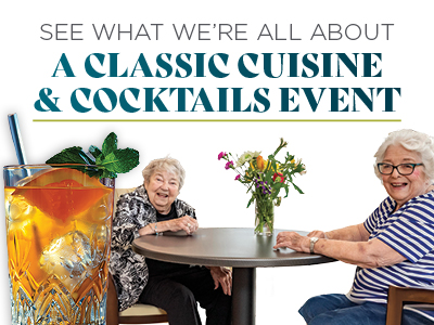 Two smiling elderly women sit at a round table with a flower vase. A large, colorful cocktail with mint is in the foreground. Text reads: “A Classic Cuisine & Cocktails Event. See what we’re all about.”.