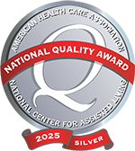 Silver circular badge displaying "National Quality Award" from the American Health Care Association and National Center for Assisted Living, with "2025 Silver" at the bottom on a red ribbon.