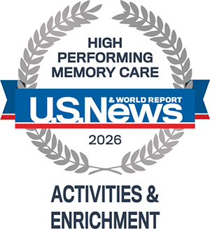 A U.S. News & World Report badge for 2026, reading "High Performing Memory Care," with "Activities & Enrichment" below, framed by a gray laurel wreath.