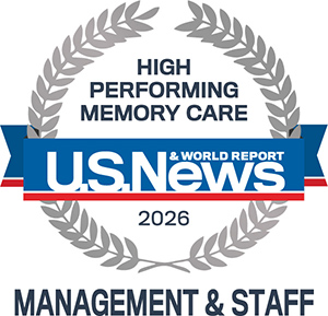 A gray laurel wreath surrounds the text "HIGH PERFORMING MEMORY CARE" above a blue banner with "U.S. News & World Report 2026." Below, it reads "MANAGEMENT & STAFF.