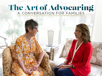 Two women sit and talk in a brightly lit living room. Text above them reads,