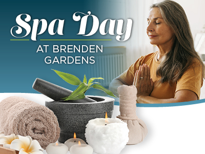 A woman with long gray hair meditates with hands in prayer position. In front, spa items like a towel, candles, a massage pouch, and a mortar with a plant. Text reads:
