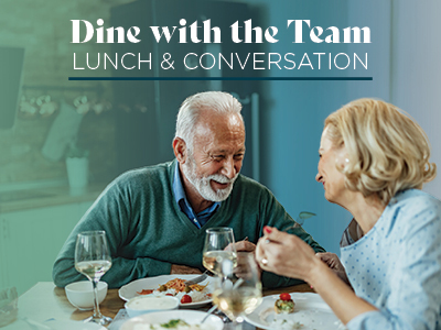 Two older adults sit at a dining table, smiling and talking over a meal with wine. Text above reads: