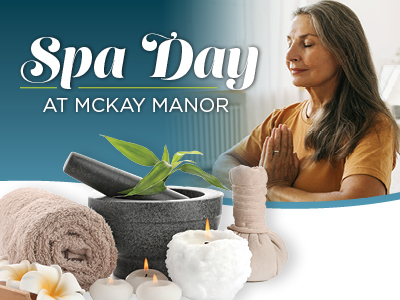 A woman meditates with hands in prayer pose. In front, spa items include rolled towels, candles, massage stones, plumeria flowers, and a herbal compress. The text reads