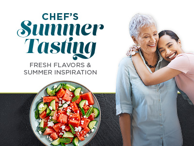 Two women smiling and embracing, next to a bowl of watermelon and cucumber salad. Text reads "Chef’s Summer Tasting: Fresh Flavors & Summer Inspiration.