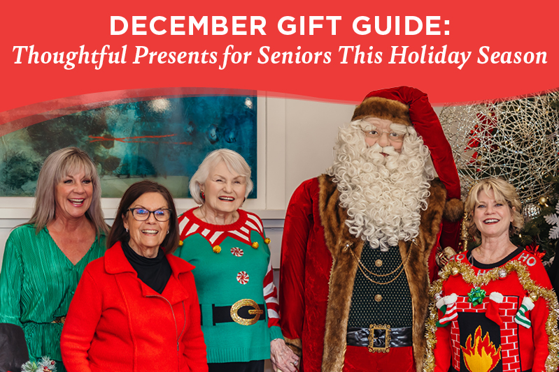 Five smiling seniors, four women in festive holiday outfits and one person dressed as Santa Claus, stand together in front of a decorated Christmas tree. Text above reads “December Gift Guide: Thoughtful Presents for Seniors This Holiday Season.”.