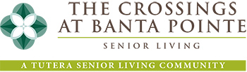 Logo for The Crossings at Banta Pointe Senior Living, featuring a green geometric flower icon and the tagline 