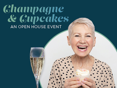 Smiling older woman holding a cupcake, with a glass of champagne next to her. Text reads "Champagne & Cupcakes: An Open House Event" on a dark blue background.
