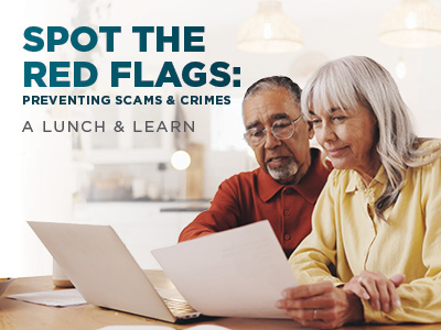 An older man and woman look at papers together while sitting at a table, with the text,