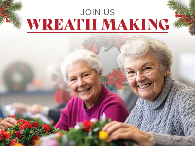 Two elderly women smiling and making festive wreaths with greenery and red flowers. Text above reads 