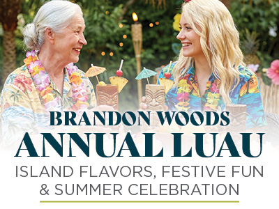 Two women in Hawaiian shirts holding tiki drinks and smiling at a tropical-themed outdoor party. Text reads: