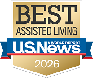 A gold badge reading "Best Assisted Living U.S. News & World Report 2026" with a blue, red, and white ribbon design.