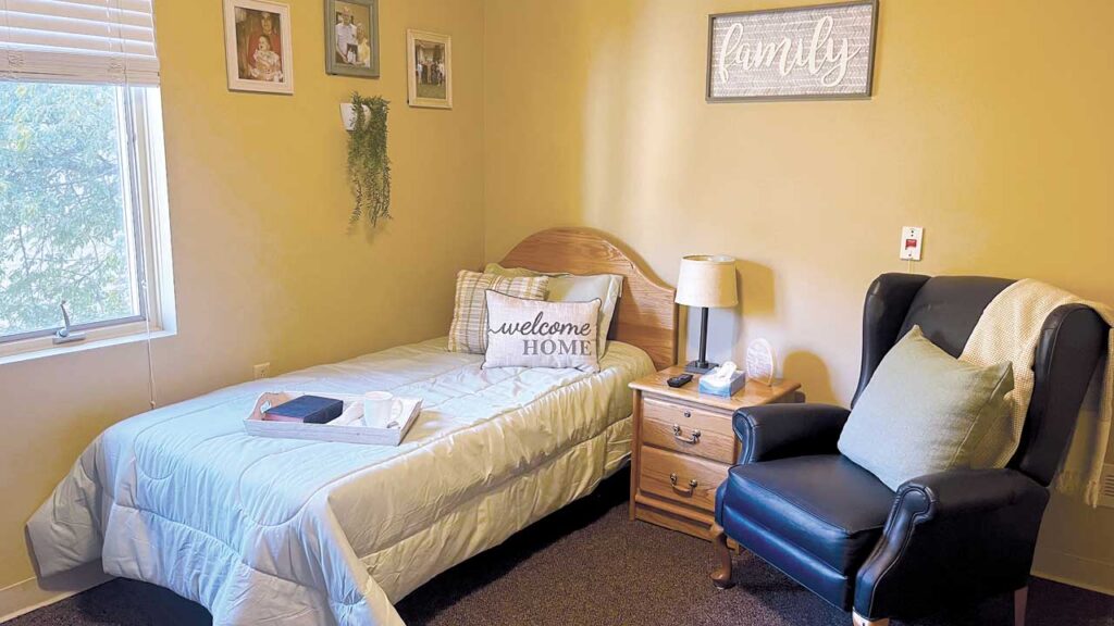 A cozy bedroom with a single bed, light blue bedding, and a